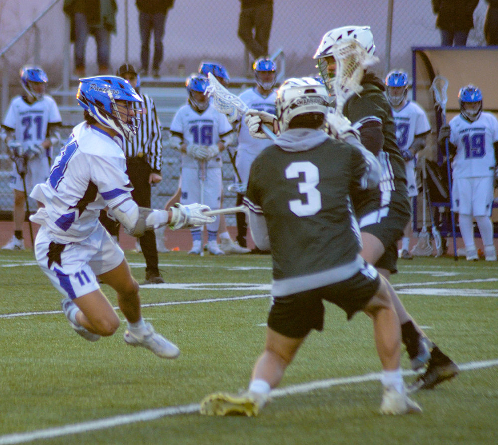 Wallkill’s Julian Gries shoots as Minisink Valley’s Nick Remund (3) and Luke Brennan defend during Wednesday’s non-league boys’ lacrosse game at Wallkill Senior High School.